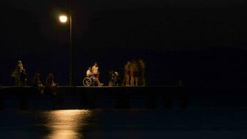 Timelapse of people on the pier at night video