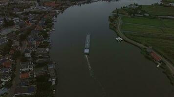 Aerial view of town and river with sailing ship, Netherlands video