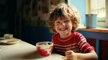 A child laughing beside a bowl of cereal photo