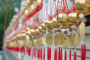 Golden red amulet as a symbol blessing for good lucky happy healthy fortune in Asian Chinese tradition, charming yellow white talisman for Chinese New Year wish for success and wealth money life photo