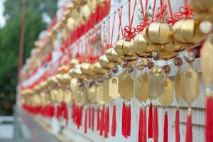 Golden red amulet as a symbol blessing for good lucky happy healthy fortune in Asian Chinese tradition, charming yellow white talisman for Chinese New Year wish for success and wealth money life photo