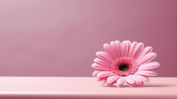 a pink flower sitting on top of a table photo