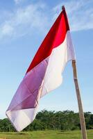 red white flag of Indonesia independence day, on blue sky background photo