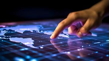 a hand touching a digital interface with a world map in the background photo