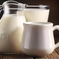 Fresh milk in a mug and jug on wooden table. AI Generative photo