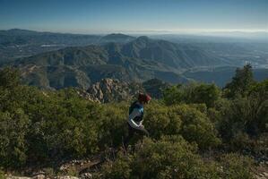 Woman runs through the mountains of Montserrat in Catalonia, Spain. photo