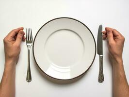 Hands separating plate and fork on white background, world food day images photo