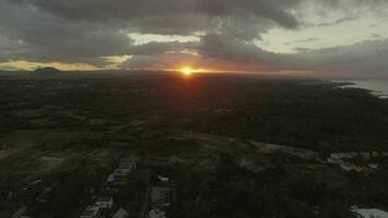 Flying over green mainland in Mauritius at sunset video