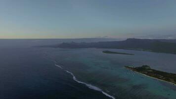 Aerial view of water line of seas that do not mix against blue sky with clouds, Mauritius Island video