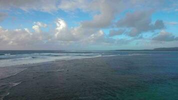 Aerial view of water line of seas that do not mix against blue sky with clouds, Mauritius Island video