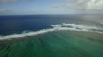Aerial view of water line of seas that do not mix against blue sky with clouds, Mauritius Island video