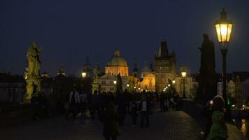 Evening cityscape with walking people on the picturesque Charles Bridge, Prague, Czech Republic video