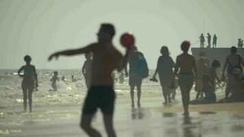 People at the seaside on hot day video