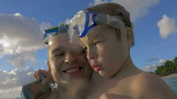 Slow motion view of happy young father with son in the water in snorkeling masks, Port Louis, Mauritius Island video