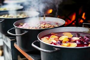 Beverages fruits and berries hot mulled wine in pots with steam in street food market. Generative AI photo