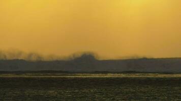 Slow motion view of ocean waves against yellow red sunset sky, Mauritius Island video