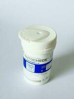 Bekasi, Indonesia on July 7 2022. Isolated white photo of a container of glucose test strips. Autocheck brand.