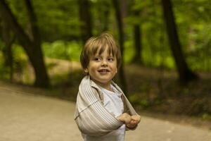 Preschooler has fun in the park. Take a walk, play and have fun. Emotions, joy. photo