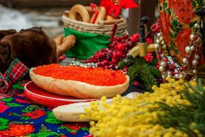 Red caviar is spread on bread with a thick layer. Maslenitsa street fair. photo