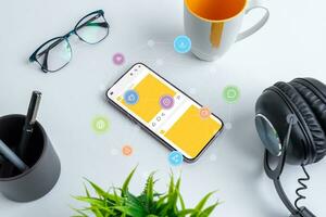 Phone on work desk with social network app and social media icons flying around with network nodes concept photo