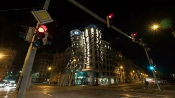 Timelapse of night traffic on junction with Dancing House, Prague video