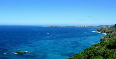 High angle view of coastline and hills calm sea photo