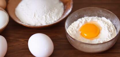 Eggs and flour ingredients at wooden table Baking homemade bread on top Baking dough Cooking background Ingredients for homemade baking 3D illustration photo