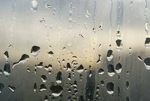 Natural water drops on window glass photo