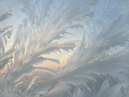 Beautiful ice pattern on window glass, natural winter texture photo