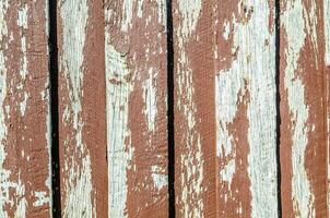 Peeling old red paint on timber wall background, elegant way of creating an eye-catching feature wall in one or multiple living areas. photo