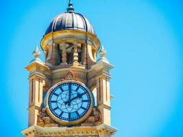 Close-up Clock tower at Sydney Central railway station heritage-listed railway station located in the centre of Sydney, New South Wales, Australia with blue sky at the background. photo