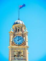 Close-up Clock tower at Sydney Central railway station heritage-listed railway station located in the centre of Sydney, New South Wales, Australia with blue sky at the background. photo