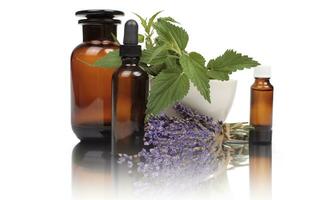 Herbal Medicine Extracts, Mortar, and Bottles on Wooden Surface photo