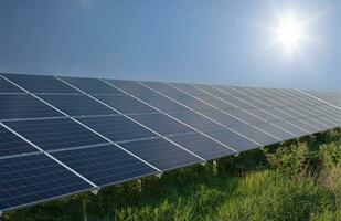 Photovoltaic Solar Panels. Clear Blue Sky, Sun, and Renewable Energy photo