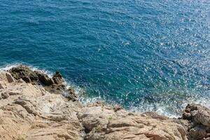 Aerial perspective of Spain's turquoise lagoon and rocky shores photo