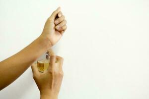 Woman's hand spraying perfume photo