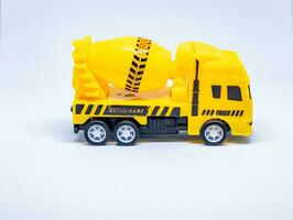 Yellow toy cement mixer truck on white background photo