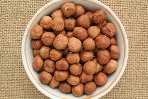 Hazelnut on eco canvas napkin background. Healthy eating, nutrition, vegan concept, vegetarian diet. Protein organic raw food. Dry snack. National nut day. Copy space for text photo