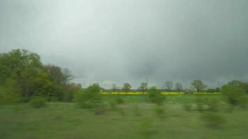 Shot of moving countryside landscape from window of train, Vienna, Austria video