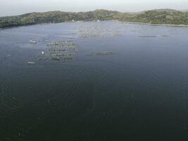 Aerial drone view of Rowo Jombro Lake with a lot of fish pond in Klaten, Indonesia photo