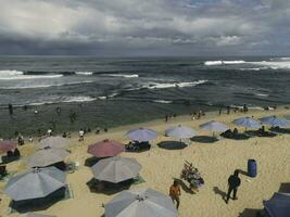 Aerial drone view of umbrellas at the beach in Yogyakarta Indonesia photo