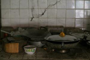 The kitchen hadn't been cleaned for years and the utensils were scattered around. photo