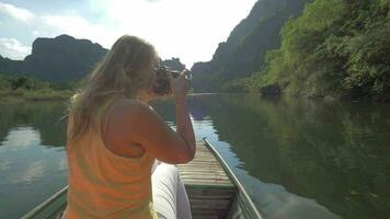 Woman tourist taking shots of Trang An nature, Vietnam video