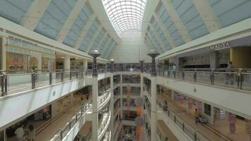 Seen a big multi-storey shopping centre with walking people video