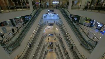 Seen a big multi-storey shopping centre with escalators and walking people video
