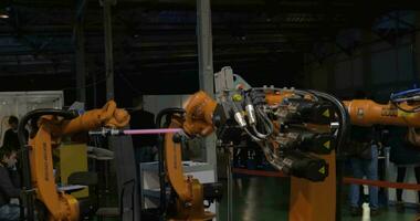 View of industrial robots that moving with light sticks video