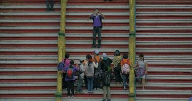 Taking photo of children on Batu Caves stairs, Malaysia video