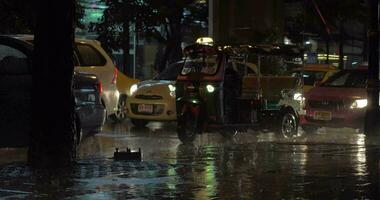 Road traffic under the rain in night city video