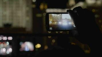 In MSU, Moscow a young man is on a concert We are together of music group Kino records video on mobile phone