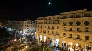 Timelapse in Thessaloniki, Greece seen panorama of evening city with architectural buildings, shops and area video
